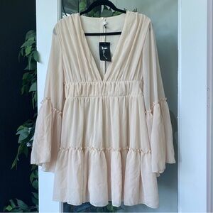New with tags Cream flowy Miss Ord dress with a flared sleeve and ruffles